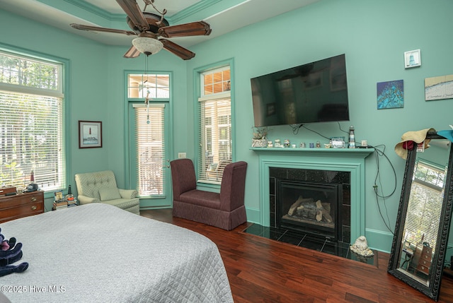 6601 Annesbrook Pl, Ocean Isle Beach, NC 28469 - bedroom featuring wood finished floors, a tiled fireplace, and ceiling fan
