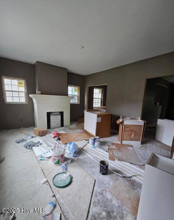 827 Sunset Ave, Rocky Mount, NC 27804 - unfurnished living room with plenty of natural light and a brick fireplace