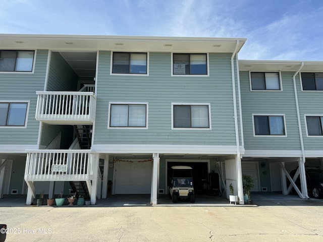 202 Lewis Dr Unit 1212, Carolina Beach, NC 28428 - view of building exterior with stairway and a garage