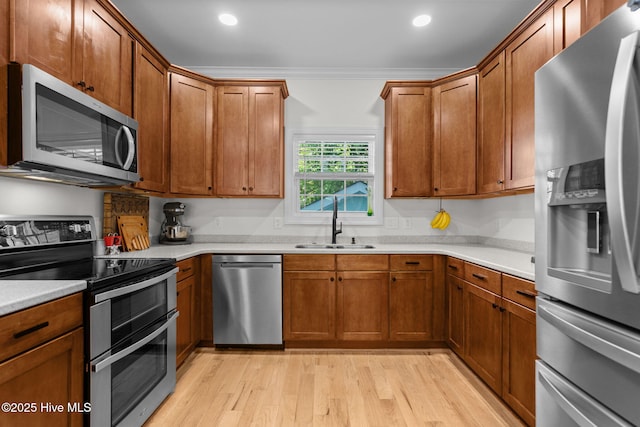 117 S 8th St, Wilmington, NC 28401 - kitchen with appliances with stainless steel finishes, light wood finished floors, light countertops, and recessed lighting