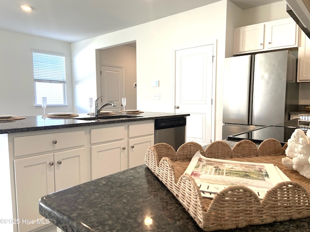 109 Mesa Ln, Holly Ridge, NC 28445 - kitchen featuring stainless steel dishwasher, freestanding refrigerator, white cabinets, and dark stone countertops
