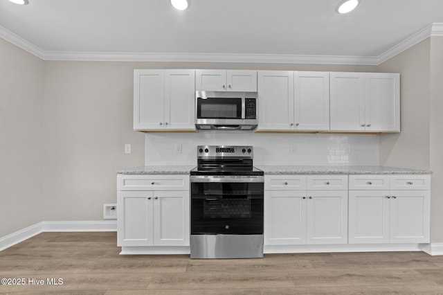 92 Hampton Way, Snow Hill, NC 28580 - kitchen featuring appliances with stainless steel finishes, crown molding, light wood-style flooring, tasteful backsplash, and light stone counters