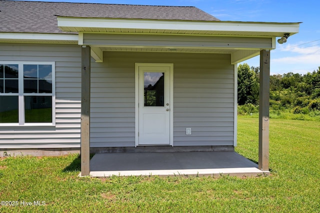 92 Hampton Way, Snow Hill, NC 28580 - view of exterior entry with a lawn and a shingled roof