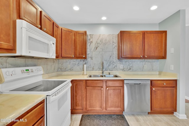 448 Edgewood & Rd, Southport, NC 28461 - kitchen with white appliances, tasteful backsplash, light countertops, recessed lighting, and brown cabinetry