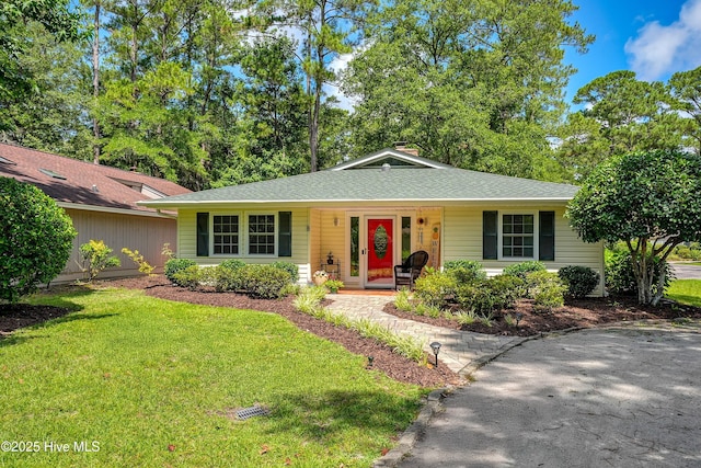 8 Gate 2, Carolina Shores, NC 28467 - view of front of property featuring a porch, a front lawn, and a shingled roof