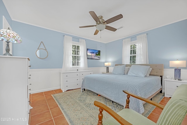 8 Gate 2, Carolina Shores, NC 28467 - bedroom featuring ornamental molding, a wainscoted wall, light tile patterned flooring, and a ceiling fan