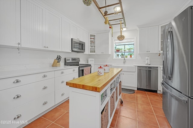 8 Gate 2, Carolina Shores, NC 28467 - kitchen featuring appliances with stainless steel finishes, wood counters, white cabinets, and light tile patterned floors