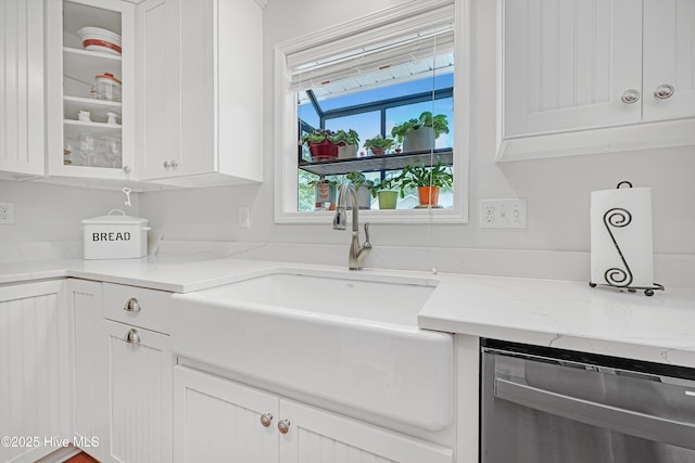 8 Gate 2, Carolina Shores, NC 28467 - kitchen featuring stainless steel dishwasher, white cabinetry, glass insert cabinets, and light stone countertops