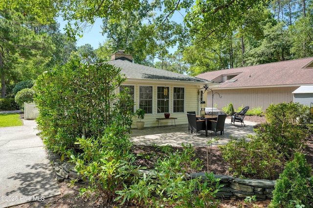 8 Gate 2, Carolina Shores, NC 28467 - rear view of house with a patio area, a chimney, and roof with shingles