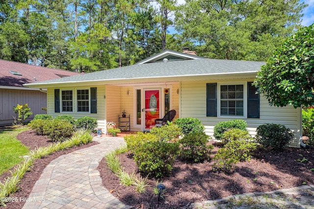 8 Gate 2, Carolina Shores, NC 28467 - view of front of property featuring roof with shingles and a chimney
