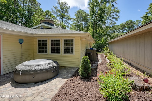 8 Gate 2, Carolina Shores, NC 28467 - view of side of property featuring roof with shingles and a chimney