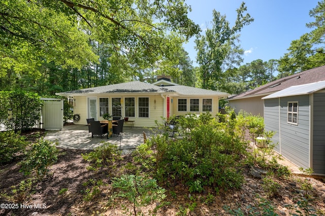 8 Gate 2, Carolina Shores, NC 28467 - back of house with a patio area and a chimney