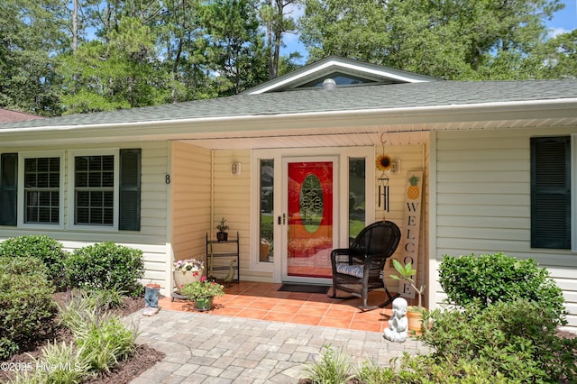 8 Gate 2, Carolina Shores, NC 28467 - property entrance with roof with shingles and covered porch