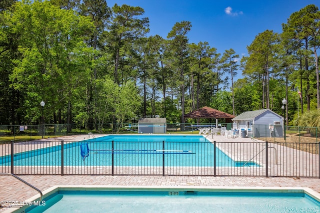 8 Gate 2, Carolina Shores, NC 28467 - community pool with view of wooded area and a patio