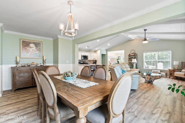 767 Heather Glen Ln, Calabash, NC 28467 - dining space featuring light wood-type flooring, a chandelier, wainscoting, ceiling fan, and crown molding