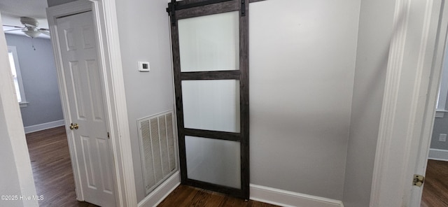 907 Raleigh Rd, Clinton, NC 28328 - hall with dark wood finished floors and a barn door