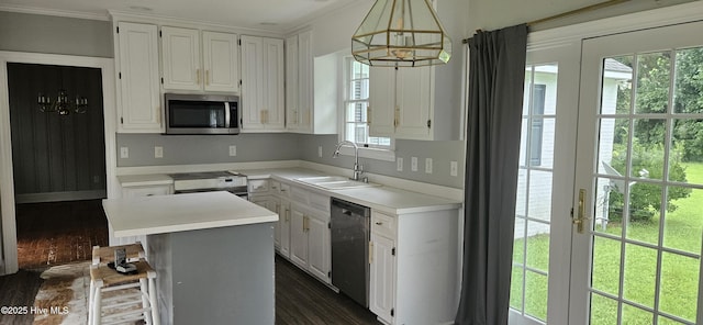 907 Raleigh Rd, Clinton, NC 28328 - kitchen with appliances with stainless steel finishes, a chandelier, white cabinets, light countertops, and ornamental molding