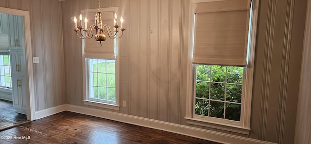 907 Raleigh Rd, Clinton, NC 28328 - unfurnished dining area featuring dark wood-style floors and a chandelier