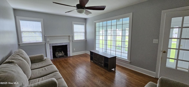 907 Raleigh Rd, Clinton, NC 28328 - living area with dark wood-type flooring, a ceiling fan, healthy amount of natural light, and a fireplace