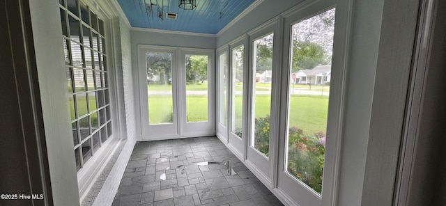 907 Raleigh Rd, Clinton, NC 28328 - unfurnished sunroom with french doors, stone tile flooring, healthy amount of natural light, and crown molding