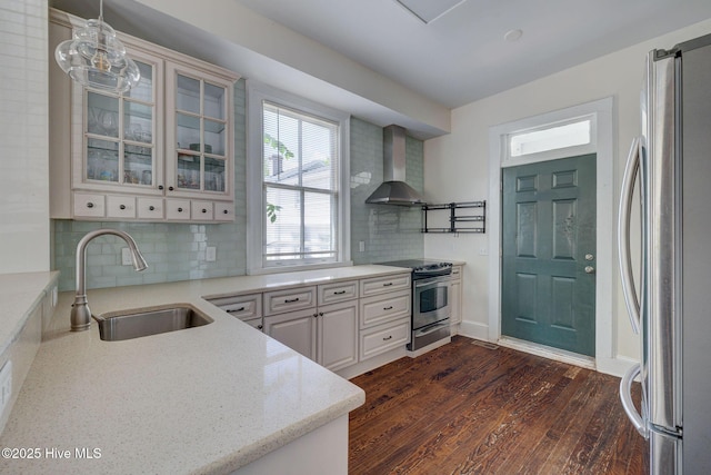 305 Mcrae St, Wilmington, NC 28401 - kitchen with appliances with stainless steel finishes, wall chimney exhaust hood, decorative backsplash, glass insert cabinets, and dark wood finished floors