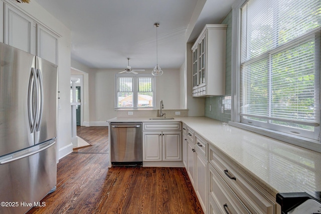 305 Mcrae St, Wilmington, NC 28401 - kitchen featuring stainless steel appliances, dark wood-style floors, glass insert cabinets, pendant lighting, and a peninsula