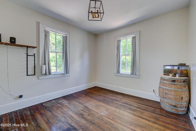 305 Mcrae St, Wilmington, NC 28401 - unfurnished room with dark wood finished floors and a chandelier