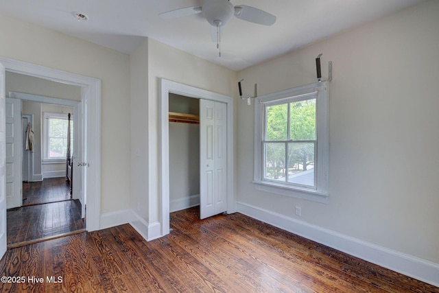 305 Mcrae St, Wilmington, NC 28401 - unfurnished bedroom featuring multiple windows, dark wood-type flooring, a closet, and ceiling fan