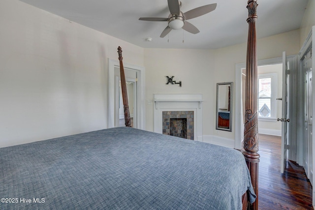 305 Mcrae St, Wilmington, NC 28401 - bedroom featuring wood finished floors, a tiled fireplace, and a ceiling fan