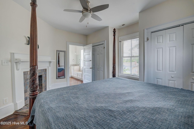 305 Mcrae St, Wilmington, NC 28401 - bedroom with wood finished floors, two closets, a fireplace, a ceiling fan, and ensuite bath