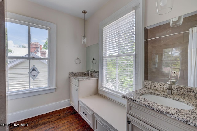 305 Mcrae St, Wilmington, NC 28401 - full bath with plenty of natural light, two vanities, wood finished floors, and a tile shower