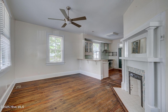 305 Mcrae St, Wilmington, NC 28401 - unfurnished living room featuring dark wood finished floors, plenty of natural light, ceiling fan, and a fireplace
