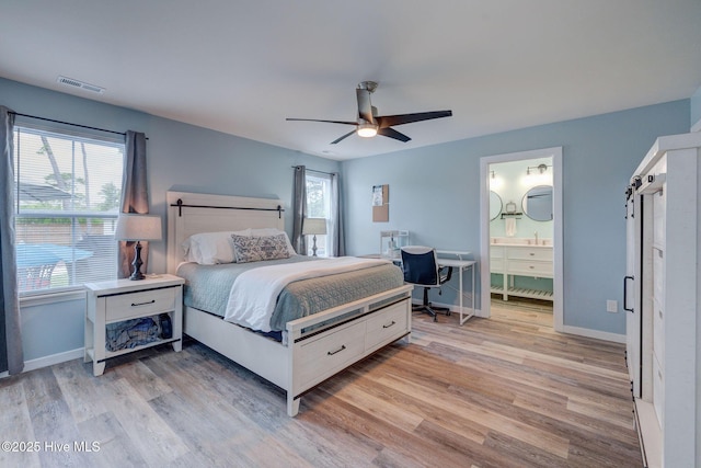 870 Westway Rd, Southport, NC 28461 - bedroom featuring light wood-style flooring, a ceiling fan, and ensuite bath