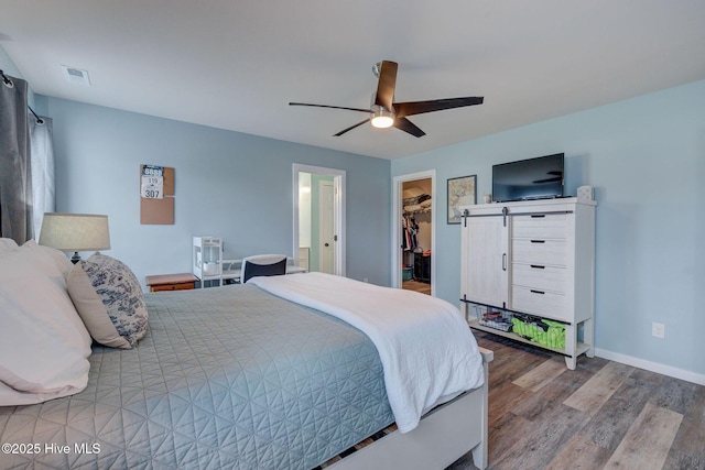 870 Westway Rd, Southport, NC 28461 - bedroom with wood finished floors, a walk in closet, a ceiling fan, and a closet