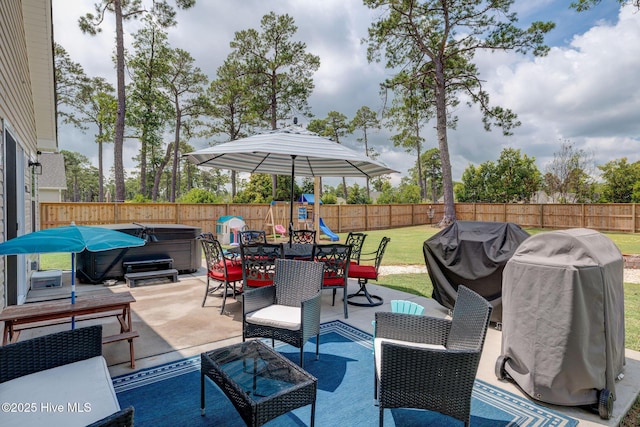 870 Westway Rd, Southport, NC 28461 - fenced backyard with a hot tub, area for grilling, a playground, a patio, and an outdoor hangout area