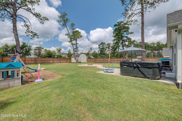 870 Westway Rd, Southport, NC 28461 - fenced backyard with a hot tub, a shed, a playground, and a patio