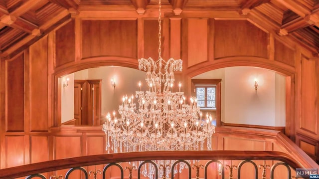 details with wood walls and an inviting chandelier