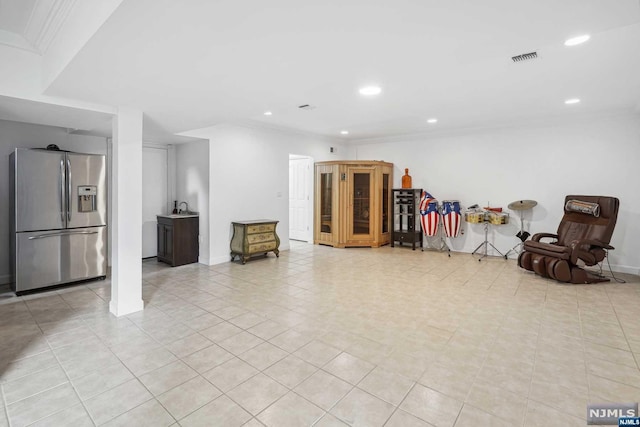 basement featuring light tile patterned flooring and stainless steel refrigerator with ice dispenser