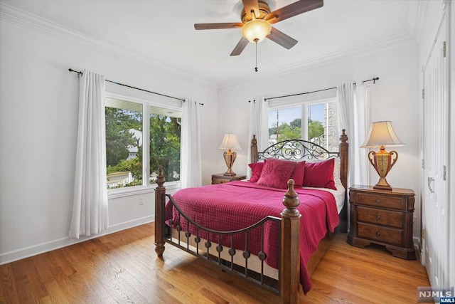 bedroom featuring light hardwood / wood-style flooring, ceiling fan, and crown molding