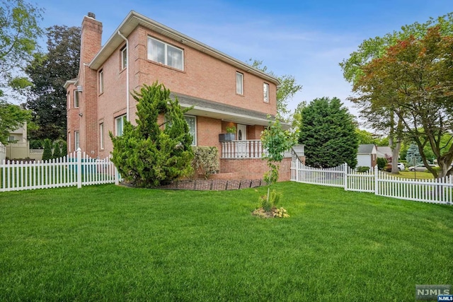 view of side of property with a yard