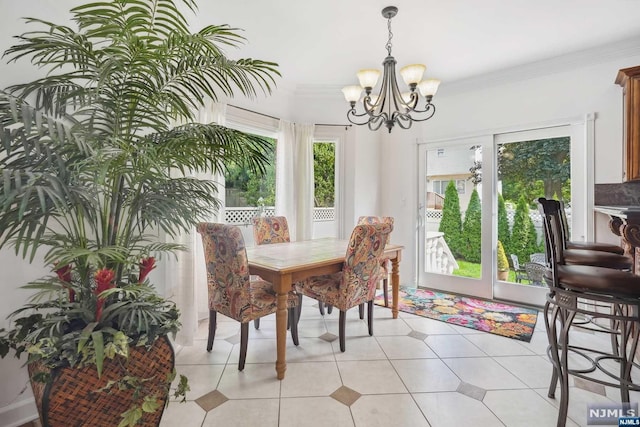 tiled dining area featuring a healthy amount of sunlight, crown molding, and a chandelier