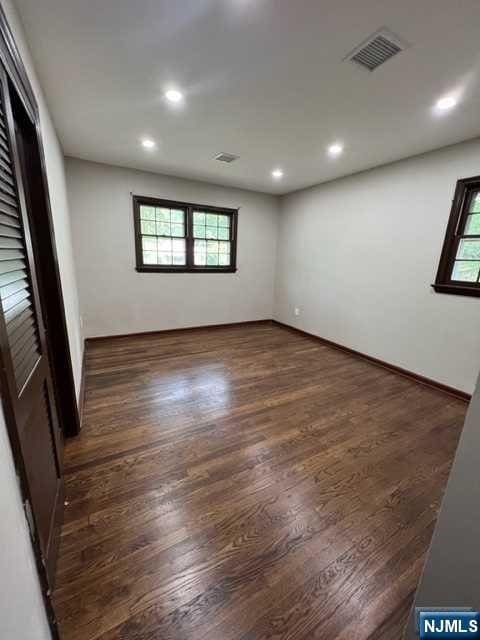 empty room featuring dark hardwood / wood-style flooring