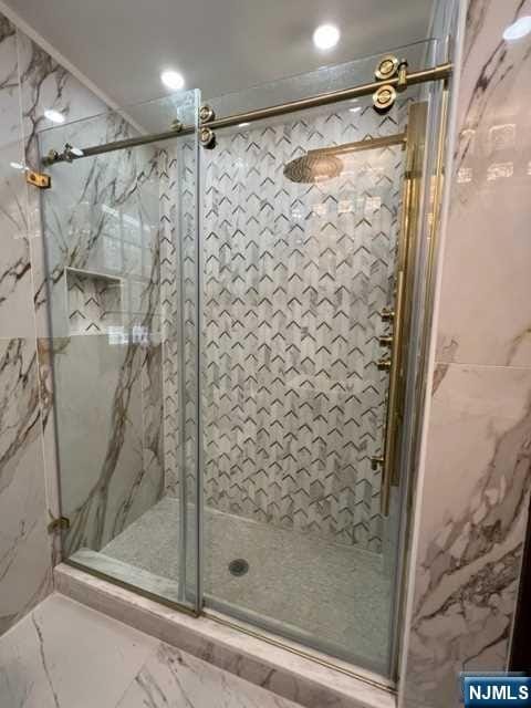 bathroom featuring a shower with shower door