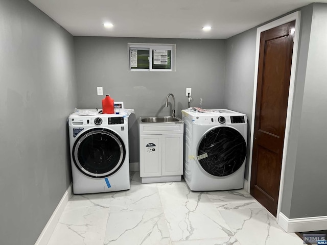 washroom featuring separate washer and dryer, sink, and cabinets