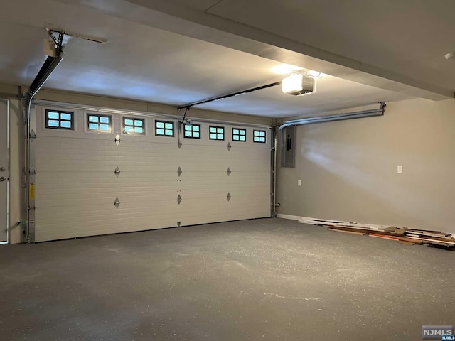 garage featuring electric panel and a garage door opener