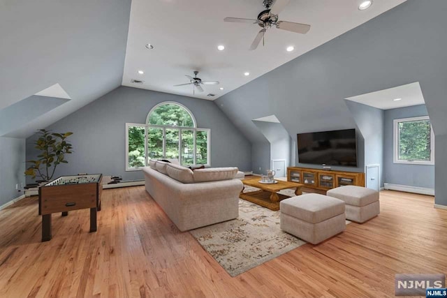 living room with vaulted ceiling, light hardwood / wood-style flooring, ceiling fan, and a healthy amount of sunlight