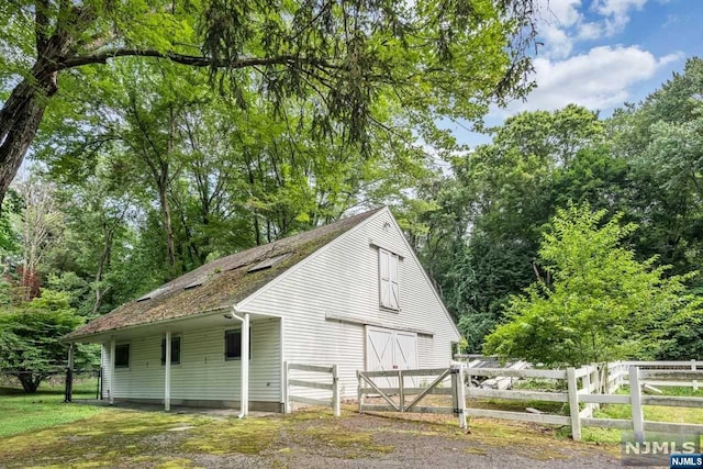 view of side of property with an outbuilding