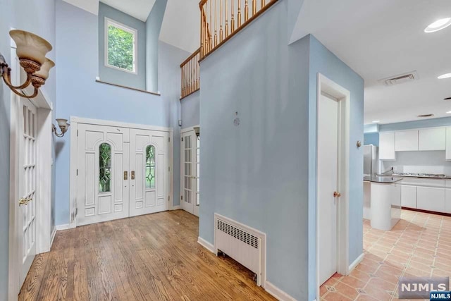 foyer featuring radiator heating unit and light hardwood / wood-style floors