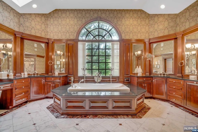 bathroom with a bathing tub, vanity, and a high ceiling