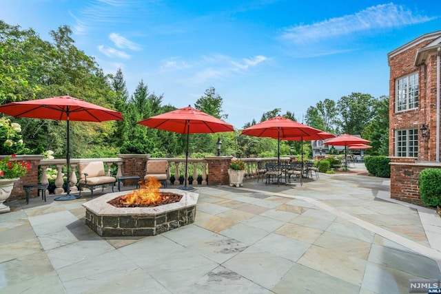 view of patio / terrace featuring a fire pit